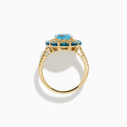 The Ocean Bleu 14K Yellow Gold Blue Topaz and Diamond Ring showcases a large oval blue topaz center, haloed by clear diamonds and marquise deep blue stones, all set on a textured yellow gold band.