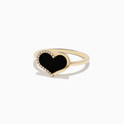 The Eclipse 14K Yellow Gold Onyx and Diamond Heart Ring features a heart-shaped black onyx centerpiece outlined with diamonds, displayed on a plain white background.