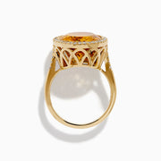The Sunset 14K Yellow Gold Citrine and Diamond Halo Ring showcases a large oval citrine center stone encircled by a sparkling diamond halo, elegantly displayed on a plain white background.