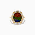 The 14K Yellow Gold Ammolite and Diamond Ring showcases a large oval ammolite center stone, encircled by two halos of sparkling white diamonds, all set in polished yellow gold.