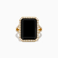 The 14K Yellow Gold Onyx and Diamond Ring showcases a large rectangular onyx bordered by sparkling white diamonds, with extra diamond accents along the elegant split band.