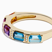 The Mosaic 14K Yellow Gold Multi Color Gemstone and Diamond Ring showcases orange, red, purple, and blue gemstones divided by gold bars with tiny diamonds, all set against a white background.