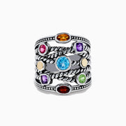 The Mosaic 925 Sterling Silver & 18K Yellow Gold Multi Color Gemstone Ring features twisted rope-style bands and seven bezel-set gemstones—blue, red, orange, yellow, purple, and green—encircling the wide ring.