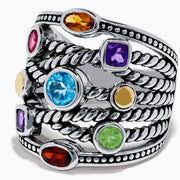 The Mosaic 925 Sterling Silver & 18K Yellow Gold Multi Color Gemstone Ring features twisted rope-style bands and seven bezel-set gemstones—blue, red, orange, yellow, purple, and green—encircling the wide ring.