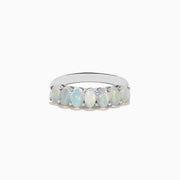 The Aurora 925 Sterling Silver Opal Ring showcases seven oval opals with iridescent hues, set closely on a sleek sterling silver band.