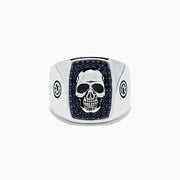 The Men's Sterling Silver Black Spinel Skull Ring features a central raised skull, small black spinel stones surrounding it, and circular engraved symbols on each side of the band.