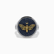 The Men's Sterling Silver Black Spinel Moth Ring showcases a gold moth and crescent moon on a round navy face, accented with sparkling black spinel stones.