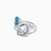 The 925 Sterling Silver Blue Topaz, White Topaz Toi Et Moi Ring features a round vivid blue topaz and a pear-shaped clear white topaz set in twisted rope-like bezels against a white background.