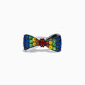 The Safari 925 Sterling Silver Multi Color Sapphire Bow Ring features red, yellow, green, and blue sapphires arranged symmetrically in a bow design against a white background.