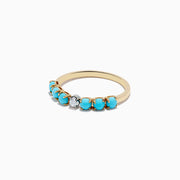 The 14K Two-Tone Gold Turquoise and Diamond Ring features a row of vibrant turquoise stones accented by a single round diamond in the center.