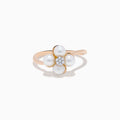 The 14K Rose Gold Fresh Water Pearl and Diamond Flower Ring features petal-shaped pearls and a central cluster of small diamonds, beautifully displayed on a white background.