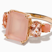 The 14K Rose Gold Pink Rose Quartz, Pink Opal and Morganite Ring features a large rectangular pink quartz center, flanked by two oval pink opals on a simple band, shown against a white background.