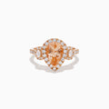 The 14K Rose Gold Pear Morganite and Diamond Halo Ring showcases a peach-hued pear morganite with sparkling diamond halo and accents, all set in 14K rose gold, against a white background.
