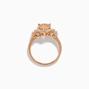 The 14K Rose Gold Pear Morganite and Diamond Halo Ring showcases a peach-hued pear morganite with sparkling diamond halo and accents, all set in 14K rose gold, against a white background.