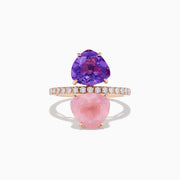 The 14K Rose Gold Amethyst, Rose Quartz, and Diamond Toi Et Moi Ring features a band of small white diamonds with a large pear-shaped amethyst set above a pear-shaped rose quartz, both arranged vertically.