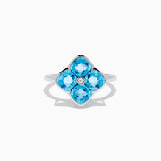 The Ocean Bleu 14K White Gold Ring features four cushion-cut blue topaz gemstones in a floral design, accented by a round diamond at the center.