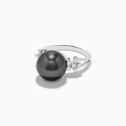 The 14K White Gold Tahitian Pearl and Diamond Ring showcases a large round Tahitian pearl at the center, accented by sparkling diamonds on each side, all set against a plain white background.