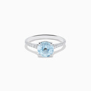 The Aquarius 14K White Gold Aquamarine and Diamond Ring showcases a large oval aquamarine centerpiece with sparkling diamonds along the band, elegantly displayed on a plain white background.