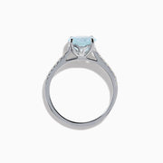 The Aquarius 14K White Gold Aquamarine and Diamond Ring showcases a large oval aquamarine centerpiece with sparkling diamonds along the band, elegantly displayed on a plain white background.