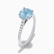 The Aquarius 14K White Gold Aquamarine and Diamond Ring showcases a large oval aquamarine centerpiece with sparkling diamonds along the band, elegantly displayed on a plain white background.