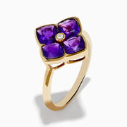 The 14K Yellow Gold Amethyst and Diamond Ring showcases a flower motif with four amethyst petals and a central round diamond, set against a white background.