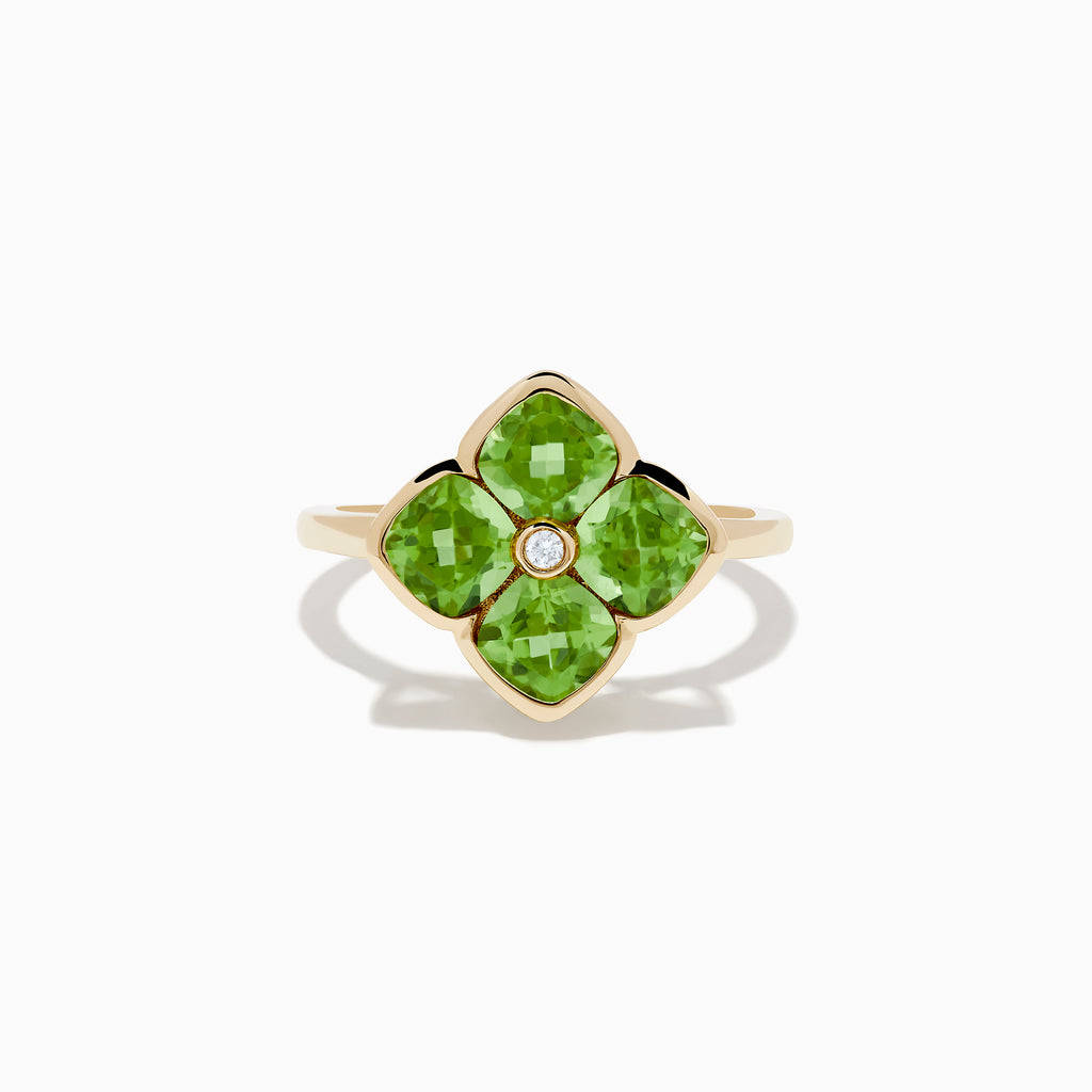 The 14K Yellow Gold Peridot and Diamond Ring displays a clover-shaped design with four faceted green peridots and a central round diamond, shown against a white background.