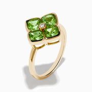 The 14K Yellow Gold Peridot and Diamond Ring displays a clover-shaped design with four faceted green peridots and a central round diamond, shown against a white background.