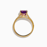 The 14K Yellow Gold Amethyst and Diamond Ring showcases a large round amethyst center accented with small white diamonds along the band, displayed on a white background.