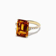 The Sunset 14K Yellow Gold Citrine and Diamond Ring features a striking rectangular citrine centerpiece accented with small round diamonds along the band, beautifully displayed on a white background.