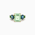 The 14K Yellow Gold Amethyst, Blue Topaz, and Chrome Diopside Cocktail Ring features a large rectangular amethyst center stone, flanked by two oval blue topaz and two smaller chrome diopside stones on each side.