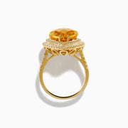 The 14K Yellow Gold Citrine and Diamond Pear Halo Cocktail Ring features a large pear-shaped citrine surrounded by a halo of round diamonds, shown on a white background.