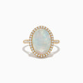 The 14K Yellow Gold Opal and Diamond Ring showcases an oval opal encircled by a halo of round diamonds, with more diamonds along the band, displayed on a white background.