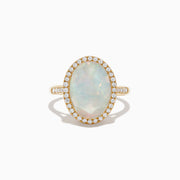 The 14K Yellow Gold Opal and Diamond Ring showcases an oval opal encircled by a halo of round diamonds, with more diamonds along the band, displayed on a white background.