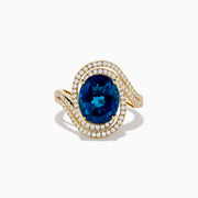 The Ocean Blue 14K Gold London Blue Topaz and Diamond Ring showcases a large oval topaz centerpiece, accented by two wavy rows of sparkling diamonds.