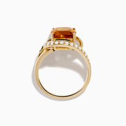 The Sunset 14K Yellow Gold Citrine Diamond Ring showcases a large cushion-cut citrine center stone, accented by curved bands adorned with sparkling diamonds.