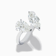 The Lab Grown Diamond Toi Et Moi Ring in 14K White Gold features two striking clear diamonds—a pear-shaped and a marquise-cut—set on open ends of the band, shown against a plain white background.