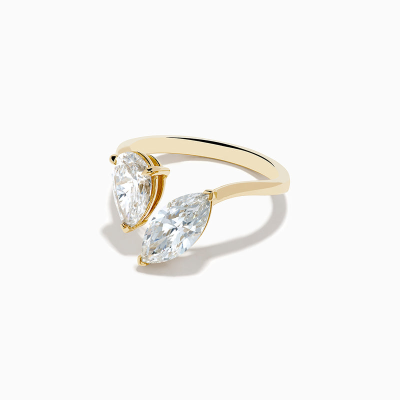 The Lab Grown Diamond Toi Et Moi Ring in 14K Yellow Gold features pear-shaped and marquise-cut lab diamonds set side by side, shown against a white background.