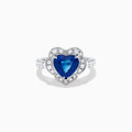 The Effy Hematian 18K White Gold Heart Shaped Blue Sapphire and Diamond Halo Ring features a heart-shaped blue sapphire center stone, a diamond halo, and additional diamonds along the band.