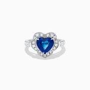 The Effy Hematian 18K White Gold Heart Shaped Blue Sapphire and Diamond Halo Ring features a heart-shaped blue sapphire center stone, a diamond halo, and additional diamonds along the band.