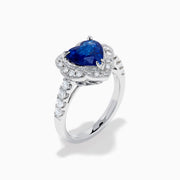 The Effy Hematian 18K White Gold Heart Shaped Blue Sapphire and Diamond Halo Ring features a heart-shaped blue sapphire center stone, a diamond halo, and additional diamonds along the band.