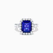 The Effy Hematian 18K White Gold Tanzanite and Diamond Halo Ring showcases a large rectangular blue tanzanite at the center, encircled by a diamond halo with additional diamonds set along the band.