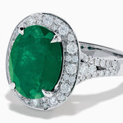 The Effy Hematian 18K White Gold Oval Emerald and Diamond Halo Ring is displayed against a pristine white background.