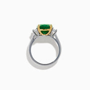 The Effy Hematian 14K Two Tone Gold Emerald and Diamond Three-Stone Ring features a large oval emerald center set with four gold prongs, flanked by two clear rectangular diamonds on a gold and silver band.