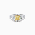 The Canare 18K Two Tone Gold White and Yellow Diamond Ring features a cushion-cut yellow diamond center, haloed by white diamonds, with extra diamonds along the split 18K gold band.