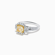 The Canare 18K Two Tone Gold White and Yellow Diamond Ring features a cushion-cut yellow diamond center, haloed by white diamonds, with extra diamonds along the split 18K gold band.