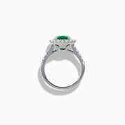 The Effy Hematian 18K White Gold Oval Emerald and Diamond Halo Ring features a vibrant oval emerald at the center, surrounded by a sparkling diamond halo with additional diamonds set along the elegant band.
