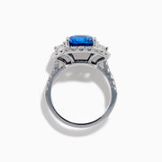 The Effy Hematian 18K Gold Cushion-Cut Blue Sapphire and Diamond Ring features a striking cushion-cut blue sapphire surrounded by a halo of round and baguette diamonds, all set in polished white 18K gold.