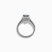 The Effy Hematian 18K White Gold Ring features a pear-shaped blue sapphire, surrounded by a halo of diamonds and set on a diamond-studded band, elegantly displayed against a white background.