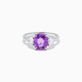 The Effy Hematian 18K White Gold Purple Sapphire and Diamond Three-Stone Ring features a large oval purple sapphire at the center with two smaller diamonds, shown on a white background.