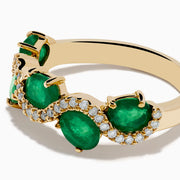 The 14K Yellow Gold Emerald and Diamond Ring features five round emeralds, each surrounded by sparkling white diamonds in a scalloped design, set on a smooth, polished gold band.